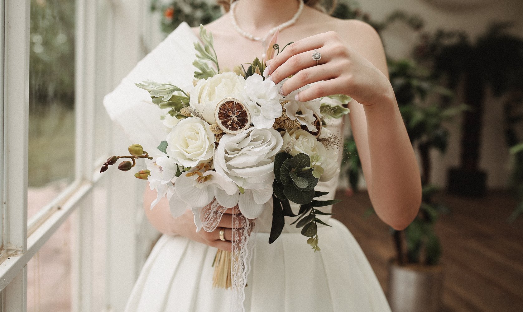 Woman in White Wedding Dress Holding Bridal Bouquet